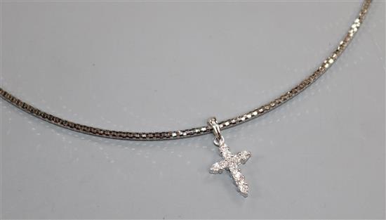 A diamond-set 18ct white gold cross on articulated suspension necklet.